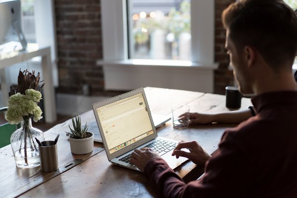 Azure consultant working on a laptop image